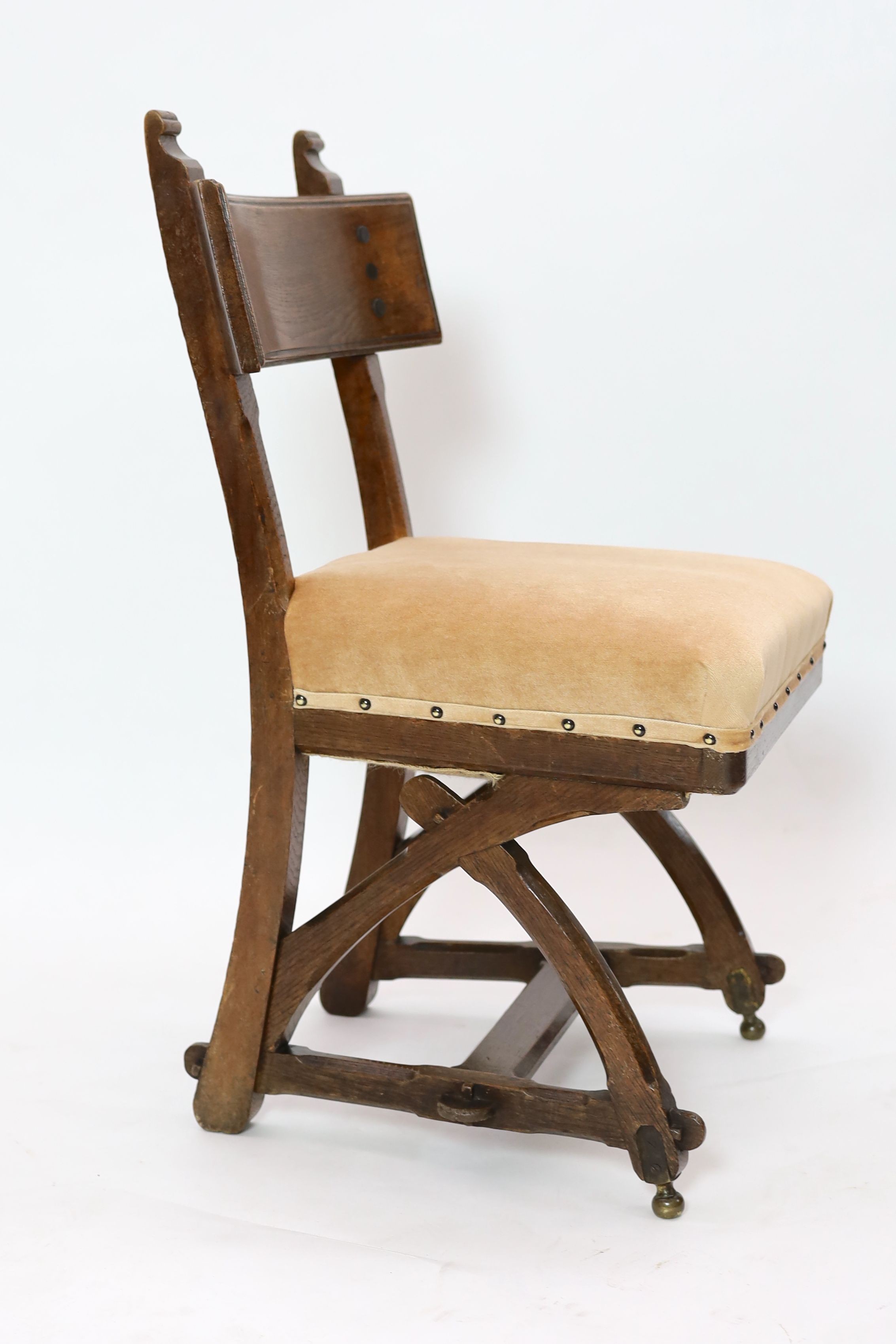A Victorian reformed gothic oak dining chair designed by Edward Welby Pugin, c.1864, W. 50cm. D. 48cm. H. 84cm.